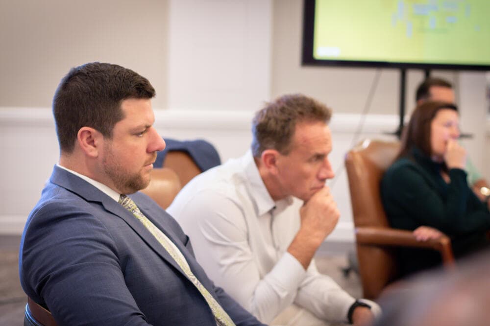 Legal professionals listening to a presentation